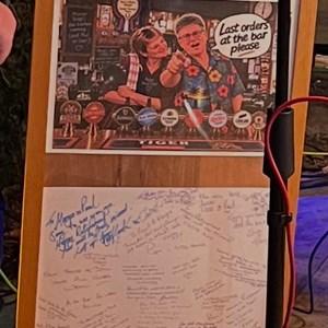 The framed well wishing card from their customers.