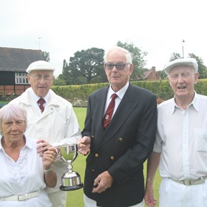 Triples: President Reg Turner presenting the cup to Shirley Avenell, Alan Newson and Len Worsdell