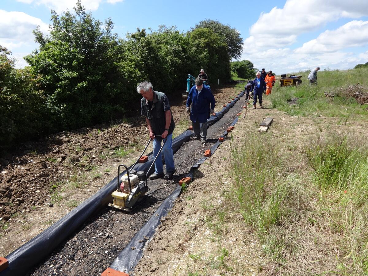 Dave and Keith tamping crushed concrete in the trench.