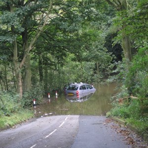 September 2008 Alvechurch Highway flooded another view with abandoned car.