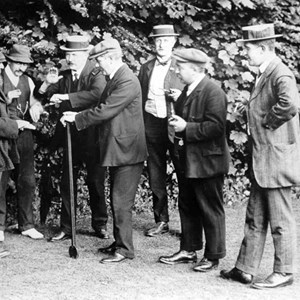 'Tossing for the Jack', before a game of bowls, c1920