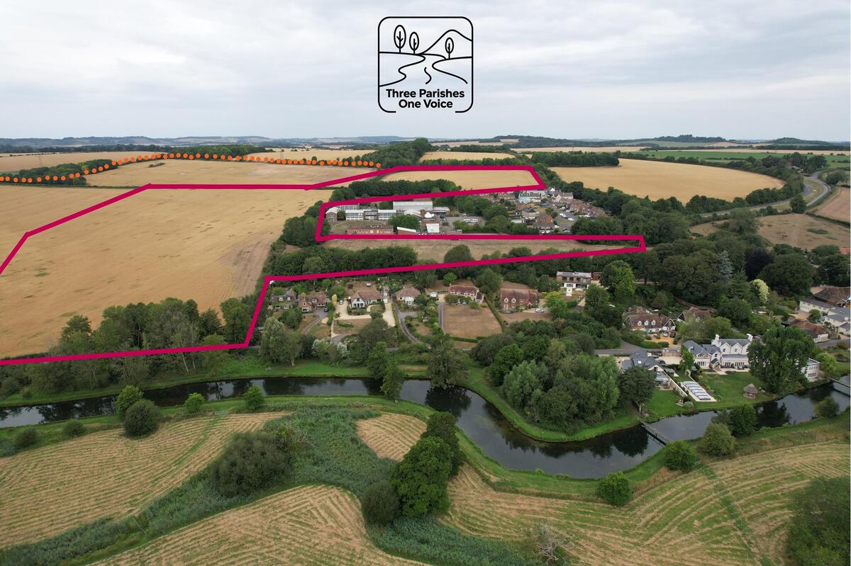 This photograph shows the site designated for the building of 100 houses outlined in red. The orange dotted line shows where the site would extend West and South for possible further development
