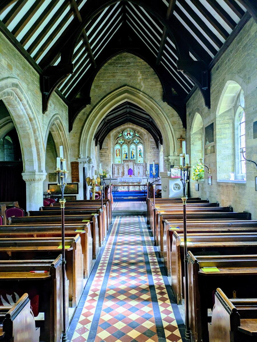 Inside the church, with pews in the fore-ground