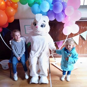 balloon arch, children and easter bunny in main hall