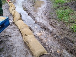 Sandbagging the track behind Dene Green March 2020