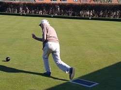 Robin, one of our older members rolling the first wood on opening the green in 2025
