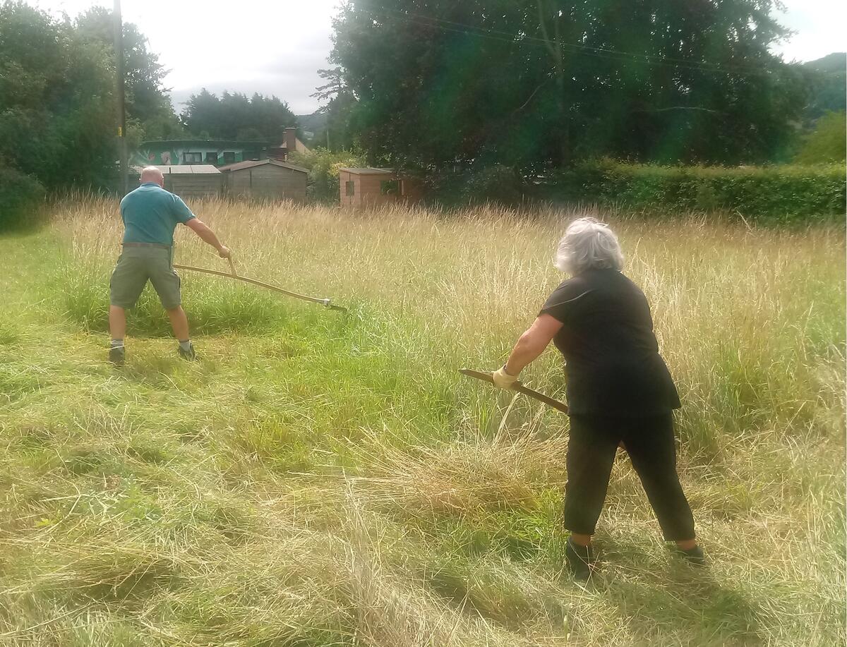 Caring for God's Acre (CfGA) volunteers scything our wildflower meadow in the churchyard...