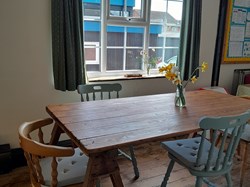 New stripped solid wood floor, freshly painted, upcycled table & chairs, donated bunting