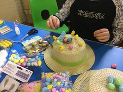 Young man making a decorated Easter bonnet