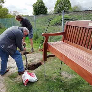 Oakley Men's Shed repaired the vandalised parish seat - now returning seat to Battledown