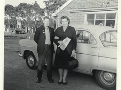 Roger Wilmot and his Mum, Mrs Eva Wilmot.  Esso filling station, next to New England Cafe, in the background