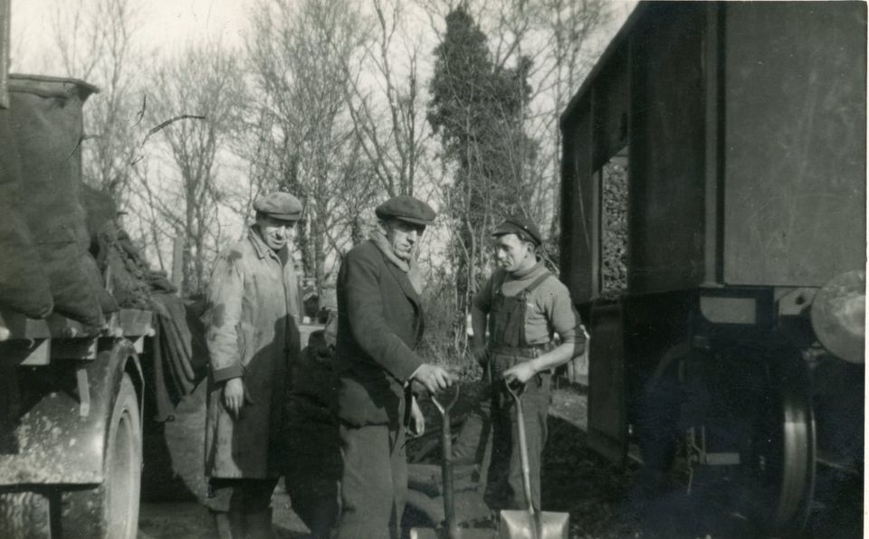 February 1955 West Meon. William Stone and a young Ray Stone on the right, loading up coal.
