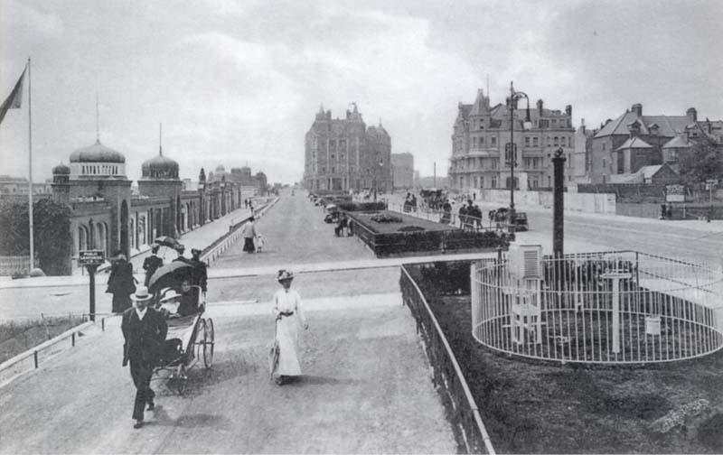[ABOVE] A photograph of the seafront at Bexhill-on-Sea around 1910. On the left is Marina Arcade, a parade of buildings built in Moghul Indian style in 1901. The Marina Arcade, a structure with distinctive ornate domes and decorative arches, housed a photographic portrait studio between 1902 and the Second World War. The shop at No. 2 Marina Arcade was first used as a photographic studio in 1902 by George E. Swain, a picture frame maker who also described himself as an "Art Photographer". By 1905, the studio at No 2 Marina Arcade had passed to the photographer William J. Reed. Between 1930 and 1938, the photographic studio at 2 Marina Arcade was in the hands of the Hastings photographer Edgar David Cooke.