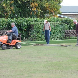 Head Green Keeper levelling the green with helpers