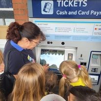 Brownies learning how to use the train ticket machine at Yeovil station