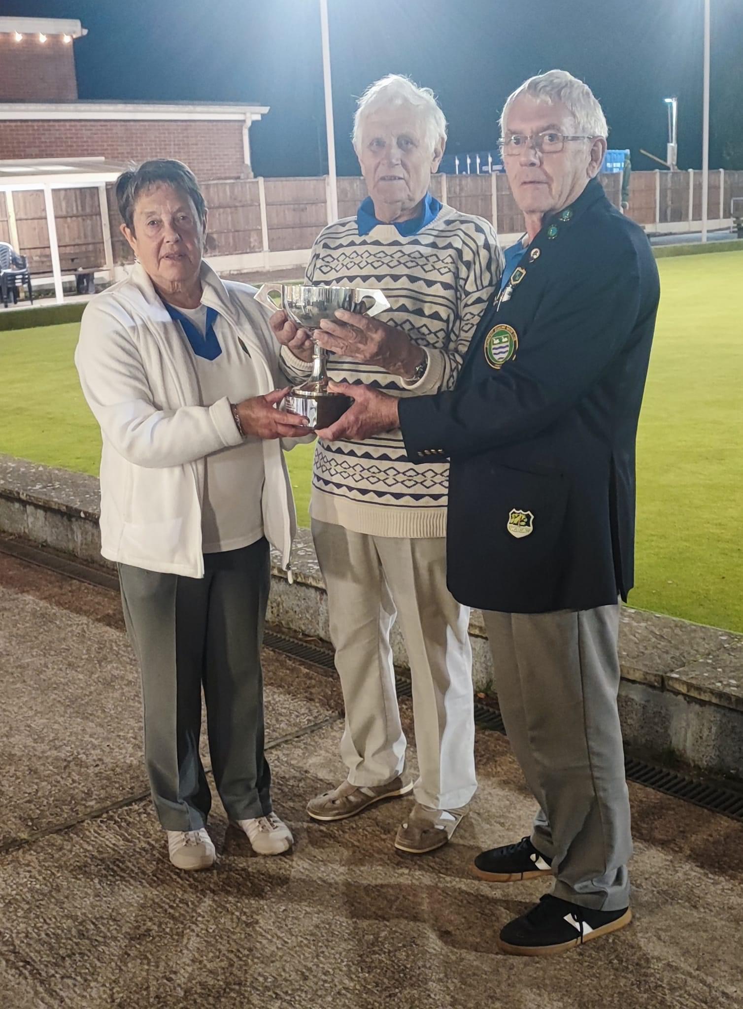 Winners Avis Beddow and T Lewis, trophy presented by President Alan Guest.