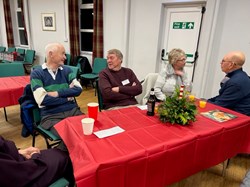 Ron Rhodes (speaker, left) chatting with John Dixon)