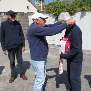 Rodney presenting Alison with her medal