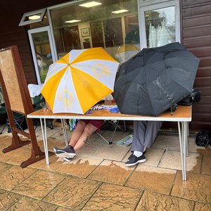 The scorers had to protect the paperwork which was getting rather wet!