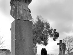 Black and white photo of headstone showing young child in old section