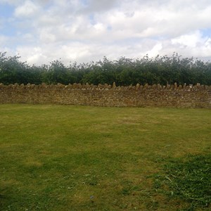 Back grassed garden showing hamstone walls