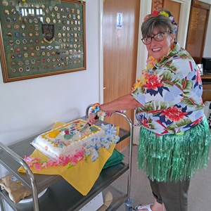 President Sue cutting her cake