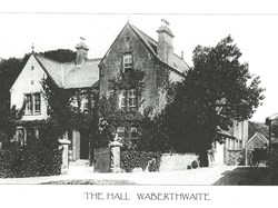 The boundary wall of Waberthwaite Hall with the Laundry just visible behind the cart