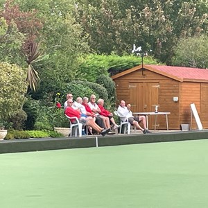 Spectating, by the brown hut