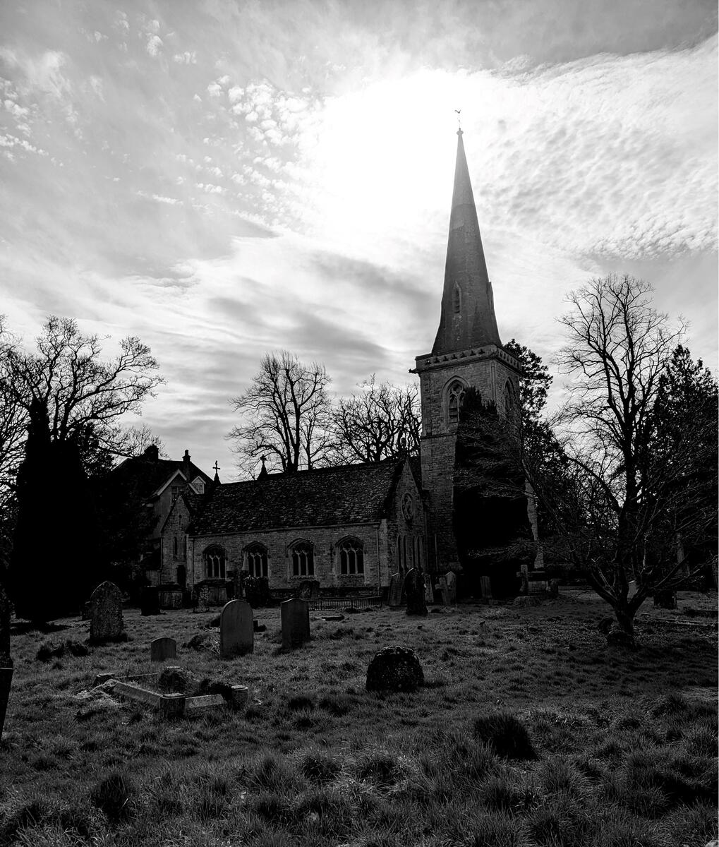 Black and white image of the church taking in the grave yard
