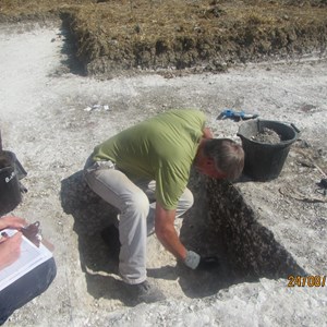 Trench 1 – Gary tidies up the side of an Iron Age pit ready for recording…