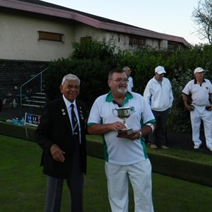 Colin Surita presents Roland Lugger with the cup