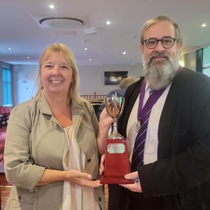 Paula on behalf of Terry Carline collecting the Winner of Mens Championship Singles