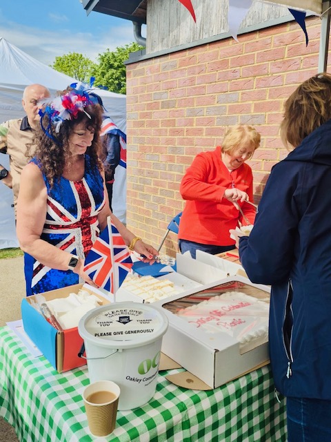 Busy volunteers cutting cake!