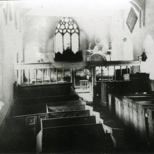 The nave before 1905. Note the Squires pew where the organ now is. It was screened from the gaze of the congregation and from draughts by curtains. The upholstery of the cushions was in blue and yellow - the squire’s racing colours.