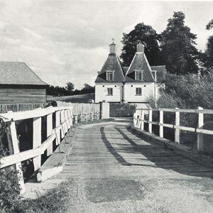 2. Approaching by the wooden bridge over the River Wey.