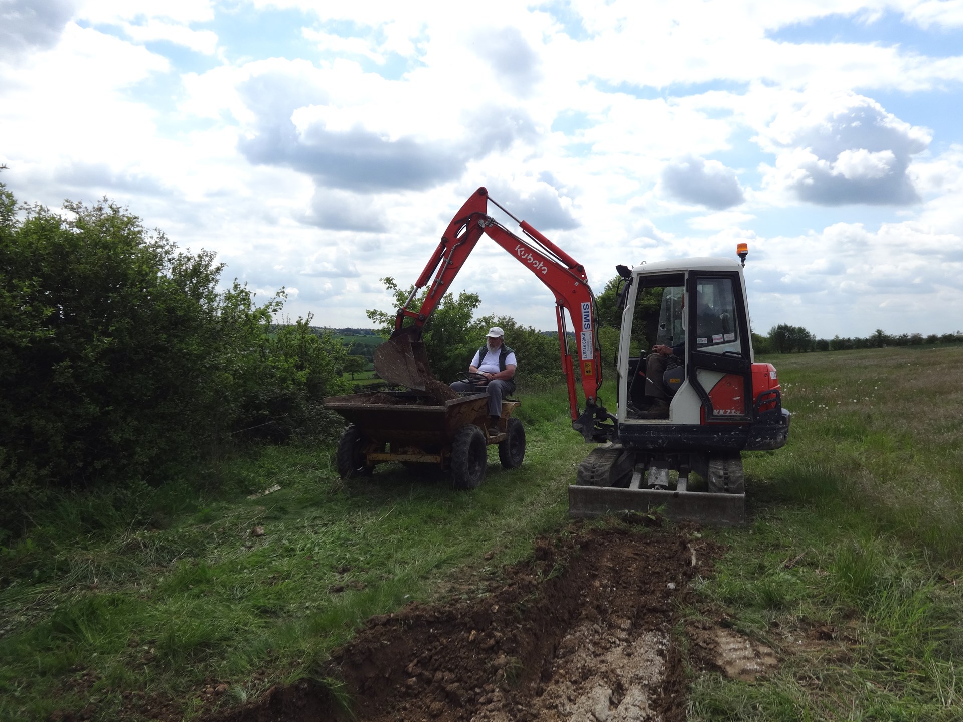 Brian in his Dumper receiving spoil from the trench dug out by Ben in the Mini Digger.