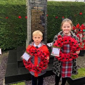 Village children lay wreathes