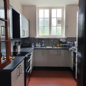Fitted kitchen showing sinks, cupboards and oven