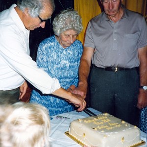 Village hall celebrating 50 years. with Kate Cheney cutting the cake with Ian Bryant along side