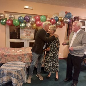 Paul Ugo greeting Brenda Barber and President Fred Goodege