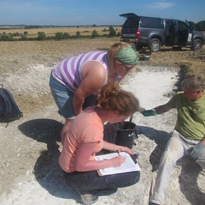 Steph from Cotswold Archaeology shows Agata how to record each context layer
