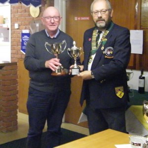 Peter Orridge holding Kings Cup & Melton Triples League Trophies