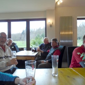 Members of Bracknell Cavaliers golf society at rest after a muddy  and wet 18 holes