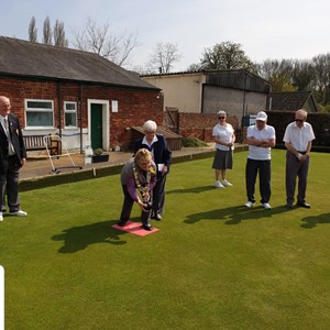 Mayor Sue Ayers delivering the first bowl to officially open the Green.