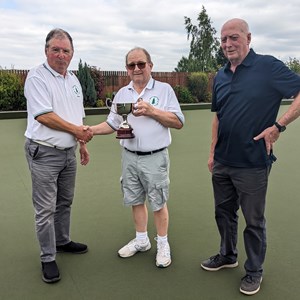 Mel presents Henry with the singles comp cup, with Geoff
