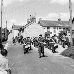 Band marching through the village dated early sixties