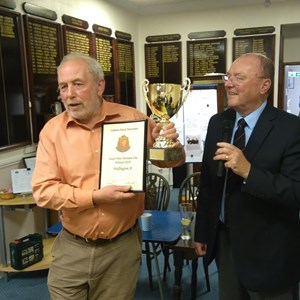 Men's captain, Paul Kelly, receives the SW Somerset Div 1 trophy from chairman Geoff Stamp
