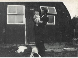 Cecil Wilmot holding son Roger Wilmot in 1948 at the nissan Huts, 106 Mile End