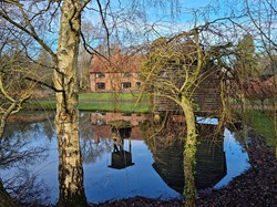 Barletts Farmhouse, beautifully  reflected in its pond. ©BT