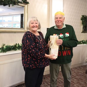 ViCe Chair Marion Jones presenting a bottle to outgoing Chair Mike Crew